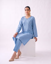 Cornflower blue embroidered kurta set, seated pose