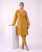 Ochre gold embroidered kurta set, standing modern pose