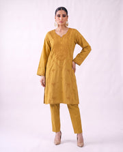 Ochre gold embroidered kurta set, hand on hip pose