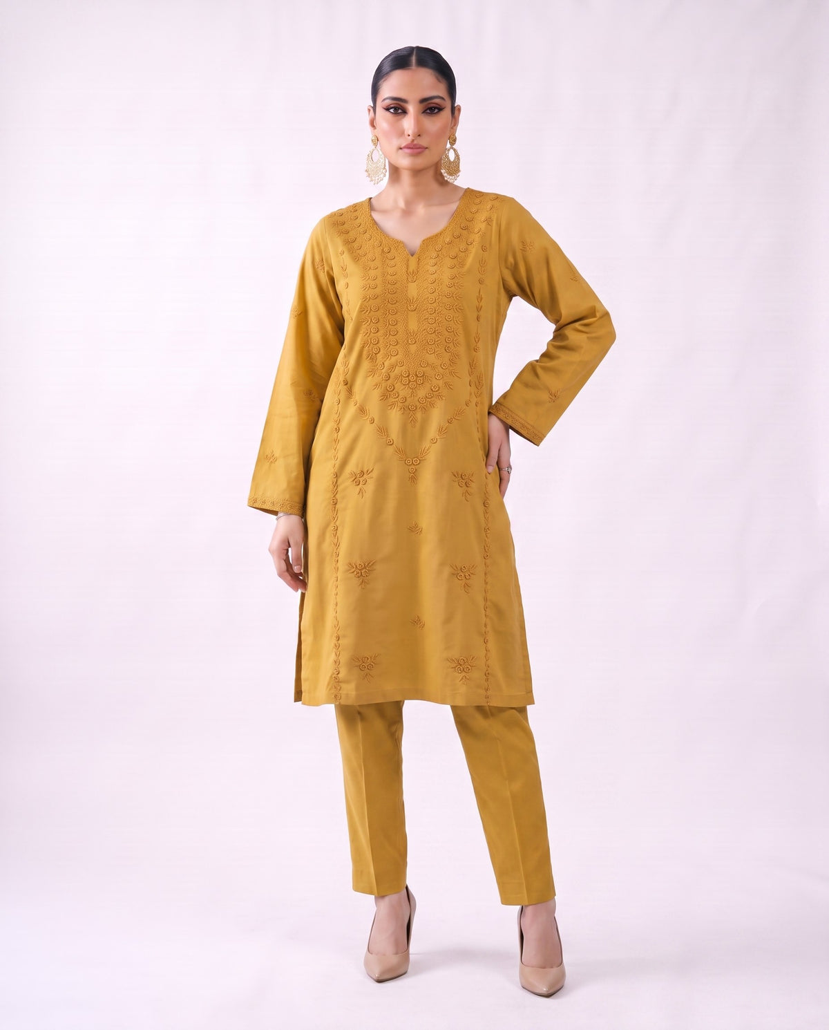 Ochre gold embroidered kurta set, hand on hip pose