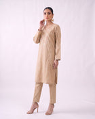 Sand beige embroidered kurta set, standing modern pose