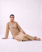 Sand beige embroidered kurta set, reclining pose